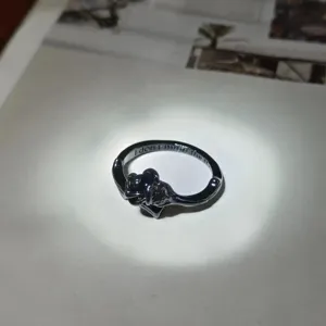 Dark gothic vintage metal ring with unique abstract design and engraved inner text detail.