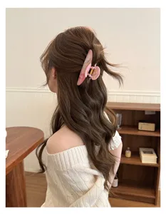 Detailed view of the pink marble hair claw clip worn by a model, showing elegant updo style.