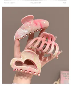 Detail view of pink marble hair claw clip, hollow design, elegant sweet hair accessory.