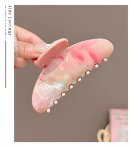 Pink marbled hair claw clip for women, sweet style hollow shark clip for elegant hair styling.