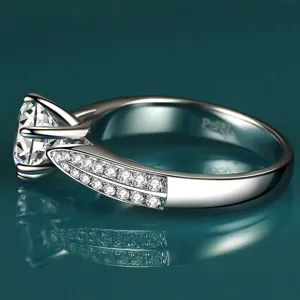 Exquisite silver moissanite ring detail showcasing sparkling pavé stones and classic claw setting.