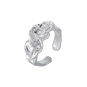 Close-up view of the irregular textured silver open ring, showing fine metallic details.