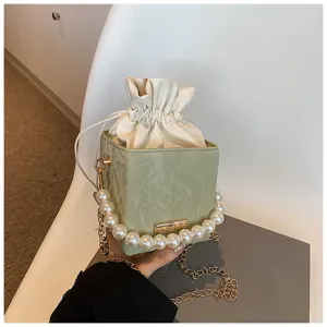 Elegant green bucket bag with pearl handle and shoulder chain, fashionable women crossbody bag.