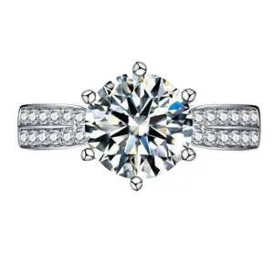 Stunning 6-prong round cut moissanite engagement ring with dazzling pave side stones.