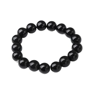 Classico bracciale con perle nere lucide, accessorio minimalista ed elegante per ogni occasione.