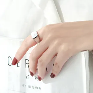 Detailed shot of a minimalist square signet ring, modern geometric smooth metal design.