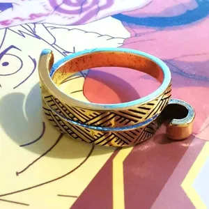 Close-up view of the adjustable gold crochet ring, featuring detailed woven pattern.