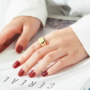 Minimalist square gold ring for women, smooth open geometric design fashion jewelry detail.