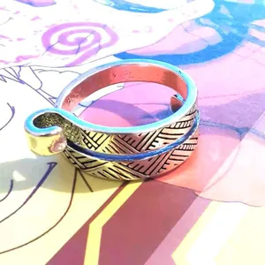 Adjustable crochet tension ring for knitting and yarn guiding, crafted with detailed silver texture.