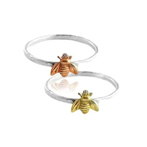 Exquisite silver-tone thin band rings featuring cute bee charms in gold and rose gold colors.
