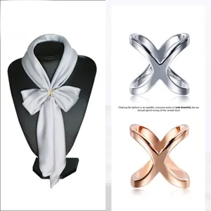 Metal X-shape scarf ring buckle, elegant fashion accessory for silk scarves and shawls.