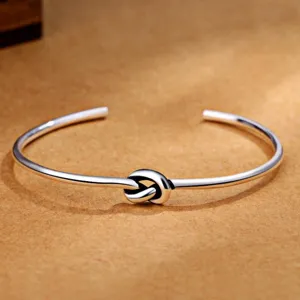 Vintage silver open cuff bracelet with elegant knot design for men and women fashion jewelry.