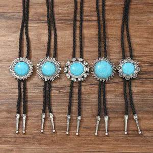 Gedetailleerd overzicht van vintage turkoois bolo-dassen met zilveren bloemhangers en zwarte koorden.