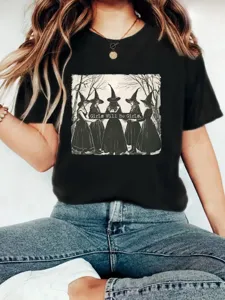 Detailed view of a black short-sleeve t-shirt featuring a vintage witch graphic and lettering.