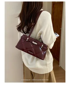 Detailed view of Korean style soft leather quilted shoulder bag, elegant burgundy armpit bag.