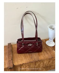 Burgundy patent leather shoulder bag with quilted diamond pattern, metal lock, and double straps.