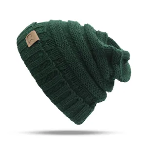 Close-up detail of dark green knitted slouchy beanie hat with a stylish leather patch.