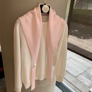 Soft knit fake collar shawl and white sweater detail view, stylish autumn layered women apparel.