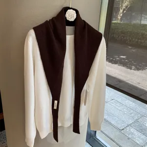 Knit sweater and brown shawl set, soft fabric, stylish layered look for autumn daily wear.