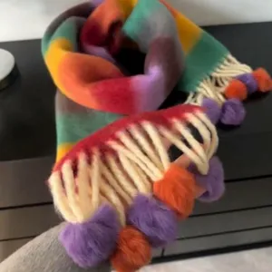 Rainbow striped fuzzy scarf with colorful pom pom tassels, soft and warm winter accessory.