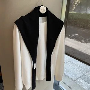 Classic black and white knit sweater set with stylish shawl collar. Warm and cozy layering.