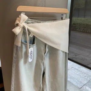 Women's light wash denim jeans with stylish white knitted wrap bow waist design autumn