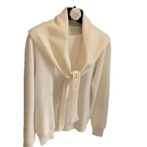 White knitted sweater set with tied scarf shawl, cozy wool blend winter chic layered outfit.