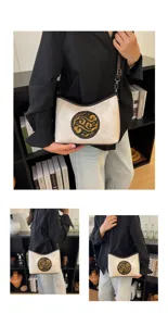 Vue detaillee du sac en cuir style chinois avec totem dore exquis et bandouliere.