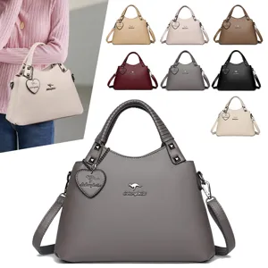 Sac à main femme en cuir PU sac bandoulière décontracté avec poignée élégante et pendentif cœur.