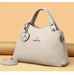Élégant sac à main pour femme en cuir PU, sac bandoulière avec pendentif cœur et bandoulière.