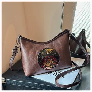 Sac à bandoulière floral gaufré rétro en cuir PU avec un design de sculpture élégant.