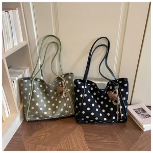 Gros plan sur le sac cabas stylé à pois en toile, grand sac d'épaule pratique pour tous.