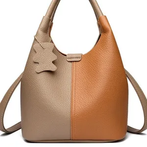 Fashionable colorblock bucket bag for women, stylish leather handbag with shoulder strap.