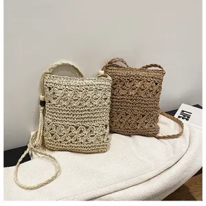 Detailed view of handmade straw woven crossbody bag, mini beach phone bag with nice texture.