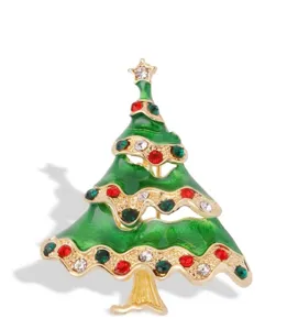 Close-up detail of the sparkling Christmas tree brooch featuring red and green rhinestones.