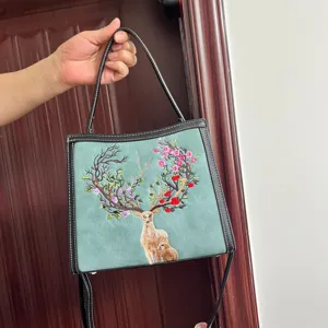 Close-up detail of the Chinese style embroidered deer handbag, featuring exquisite art.
