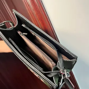 Handbag interior detail showing multi-compartment zipper design for women's crossbody bag.
