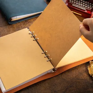 Handmade craft paper scrapbooking photo album with metal ring binder for DIY memories.