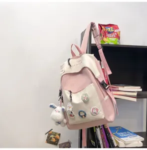 Casual student backpack detail showing pink and white color block design with cute decor.