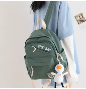 Compact green canvas backpack for women, casual waterproof daypack with cute duck pendant.