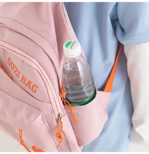 Close-up detail of the pink mini backpack side pocket with water bottle, casual everyday style