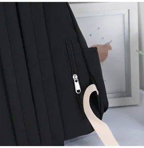Detailed view of black women small backpack side zipper pocket and adjustable strap design.