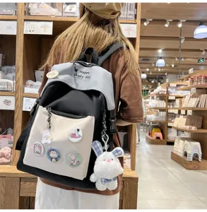 Casual colorblock school backpack with cute plush bunny pendant and badges for daily student use.