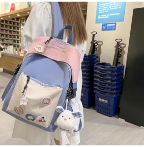 Casual colorblock school backpack for students, stylish daily daypack with cute pendants.