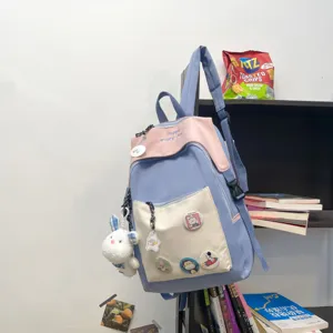 Student casual backpack stylish blue pink color block school bag with front pocket and cute plush charm
