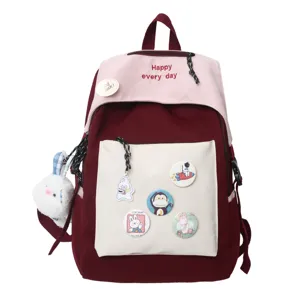 Casual canvas school backpack for students, trendy color block daypack with badges and pendant.