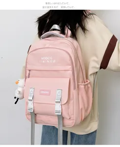 Zaino casual da studente rosa con grande capacità, tasche anteriori e simpatico ciondolo.