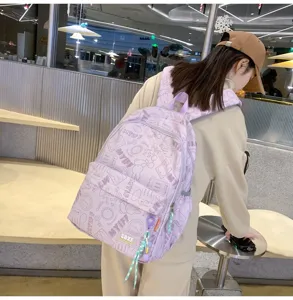 Detailed view of the cute purple casual backpack with cartoon prints and large capacity design.
