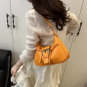 Chic orange leather hobo bag for women, vintage crescent shoulder bag fashion trend.