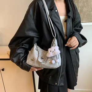 Stylish silver shoulder bag with cute cloud pendant and butterfly decor for women.